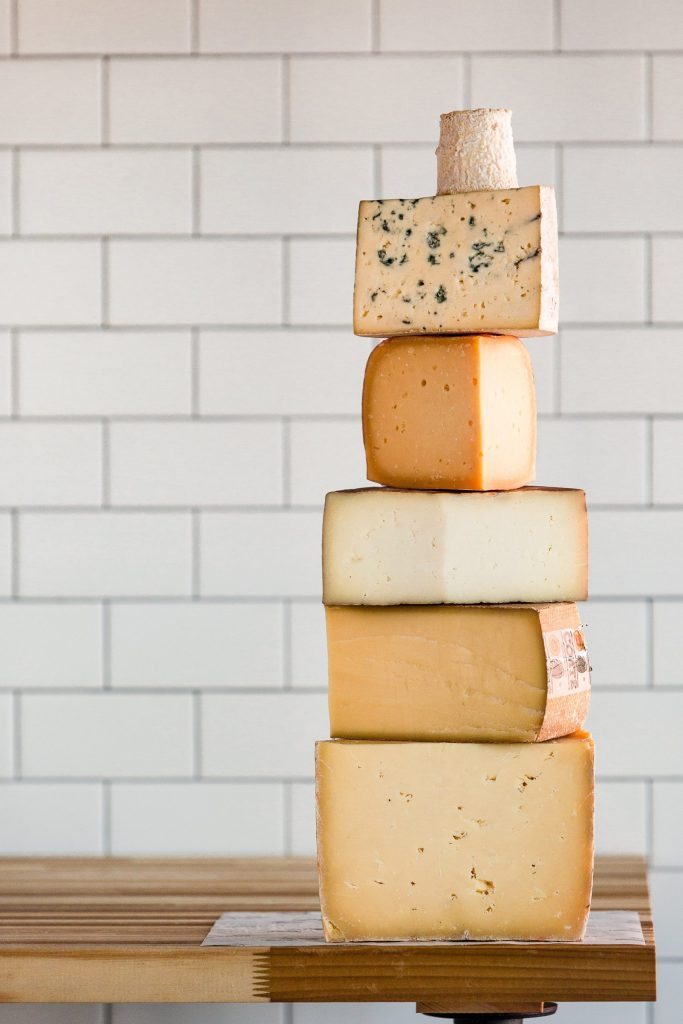 cheese stacked atop a table