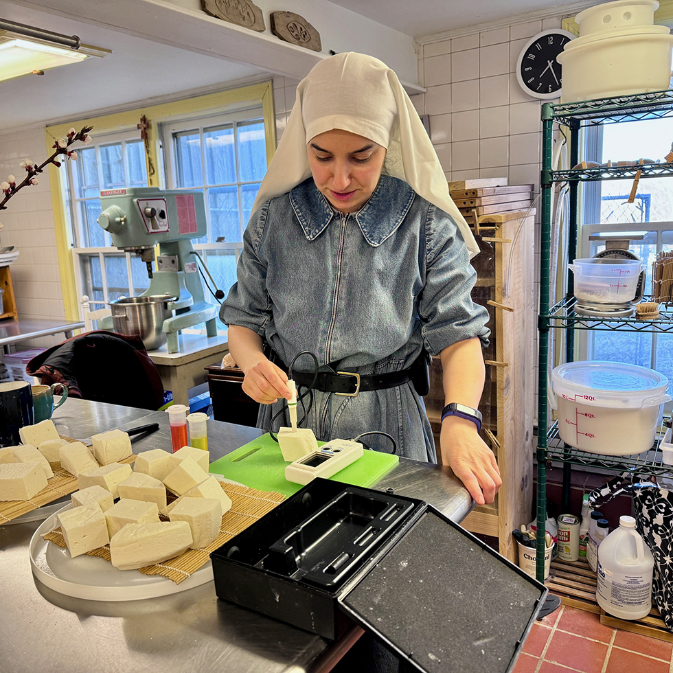cheese being measured by member of abbey of regina laudis