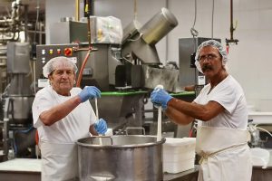 Nick and Lino making cheese at the factory